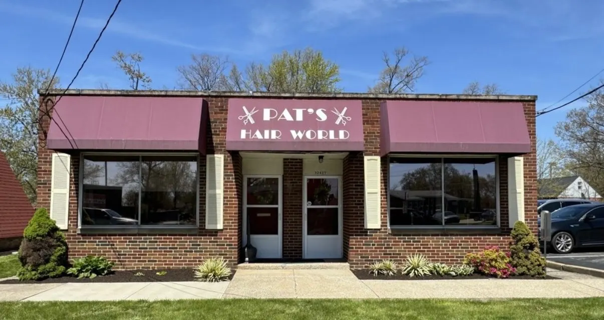 Brick building with maroon awnings, Pat's Hair World, on Vine Street in Willowick
